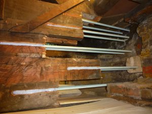 An image showing an attic that has undergone some piping work to help with stability and structural support