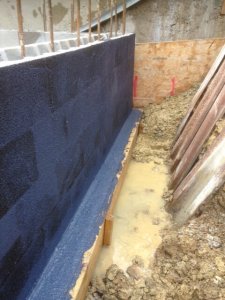 An image showing a construction area that has been damp proofed and will be a basement conversion once finished