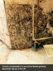 An image showing chronic condensation and dampness causing a wall to have rot in a residential home